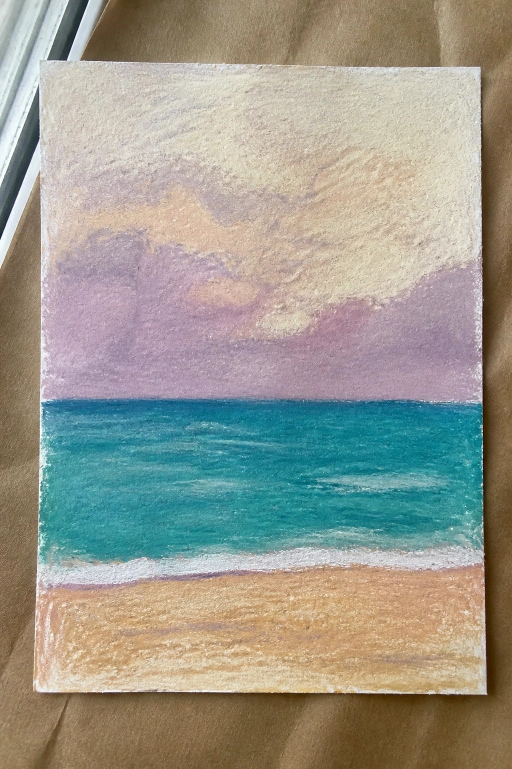 Pastel painting of purple sky over turquoise sea with white waves and sandy shore