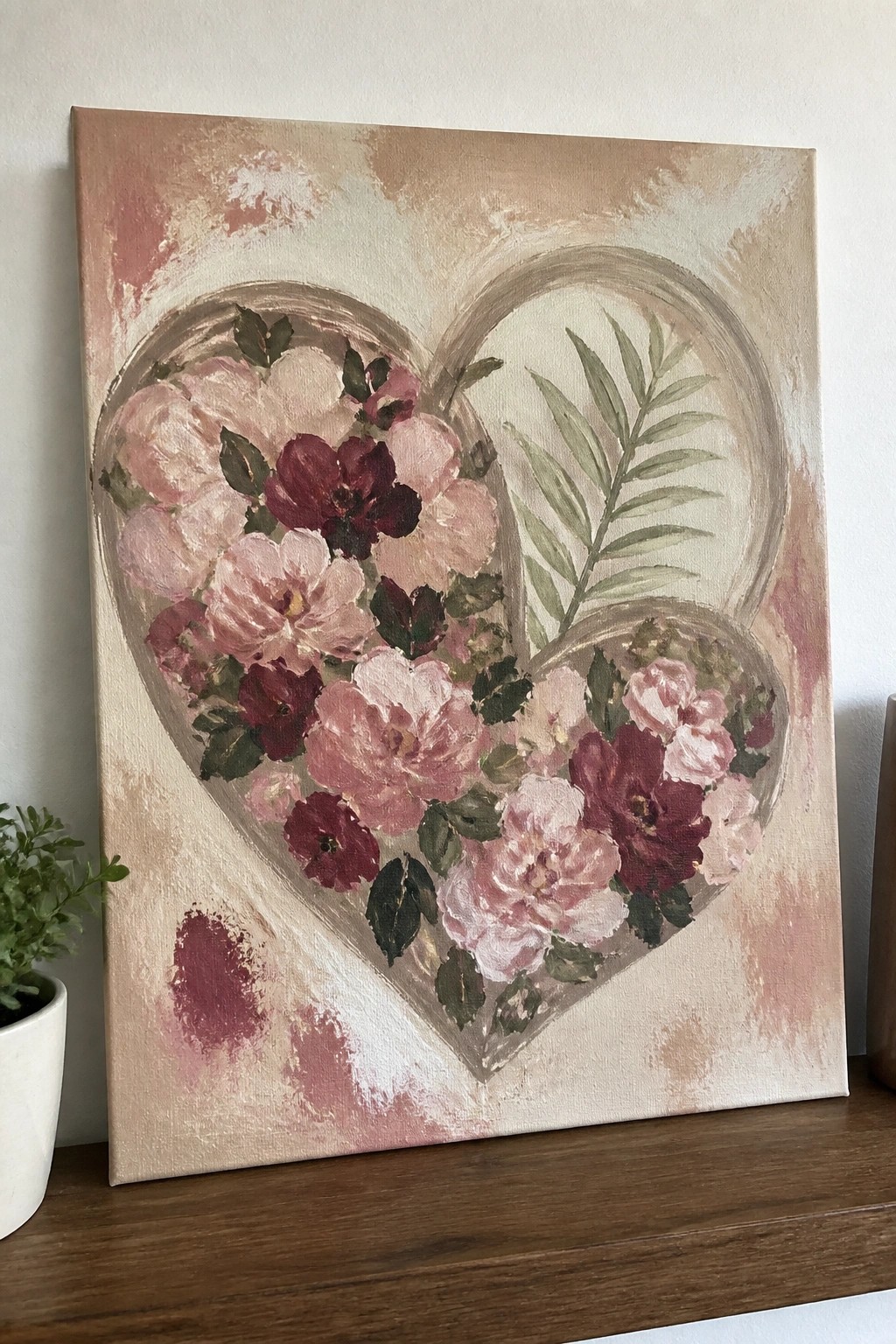 Two overlapping hearts filled with pink and maroon roses on beige canvas