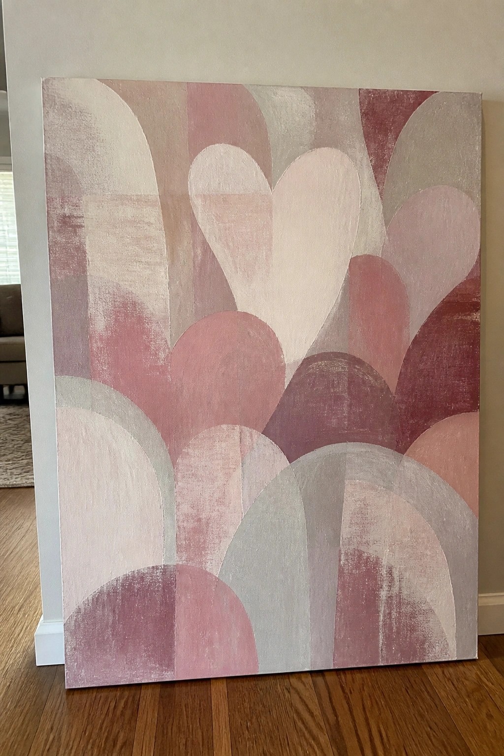 Abstract painting with overlapping arches in pink, red, white, and gray tones