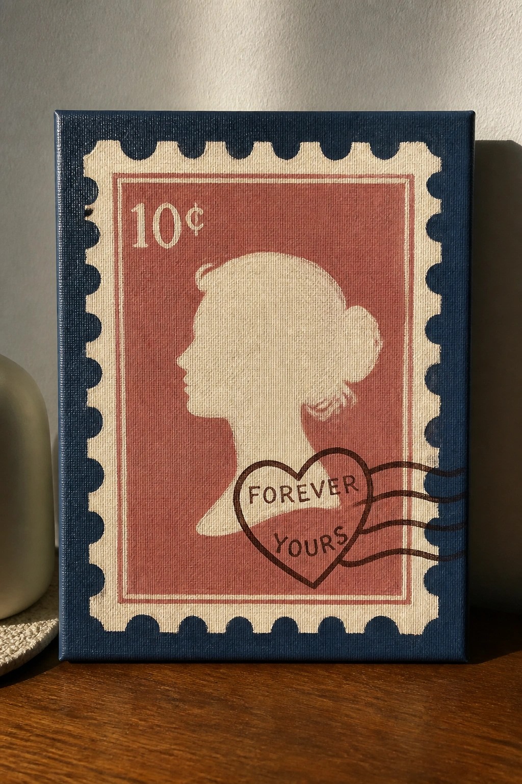 Canvas painting of red postage stamp with woman's silhouette, 10¢ and forever yours heart.