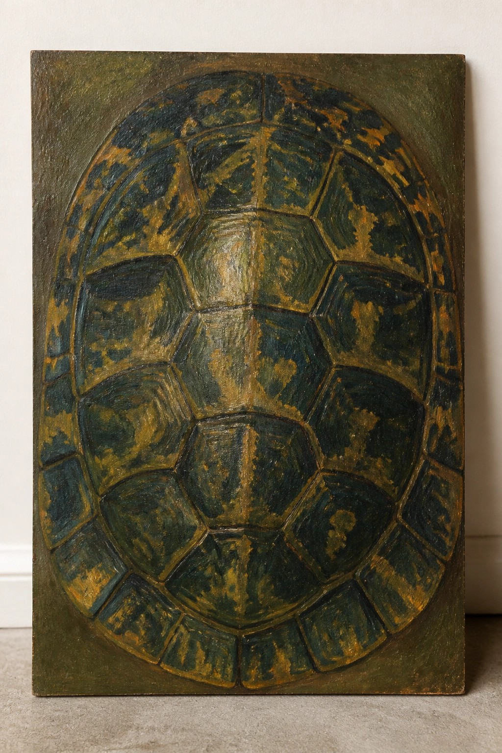 Oval turtle shell painting with segmented green, blue, and golden patterns