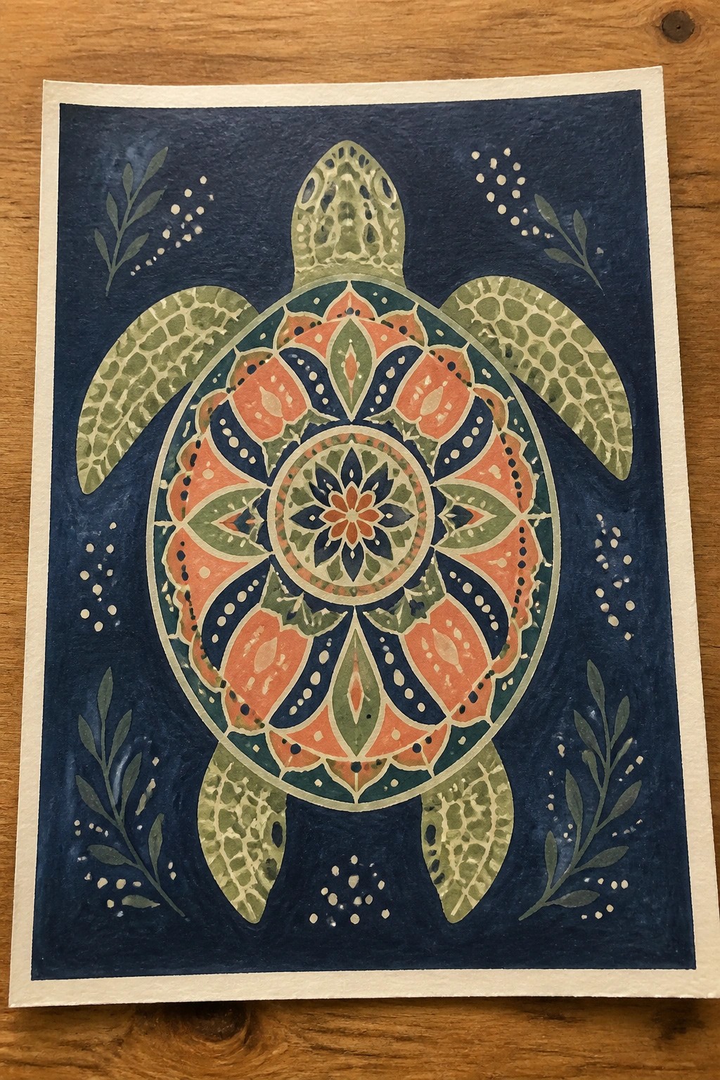 Mandala sea turtle in coral, teal, and sage green watercolor on dark blue background