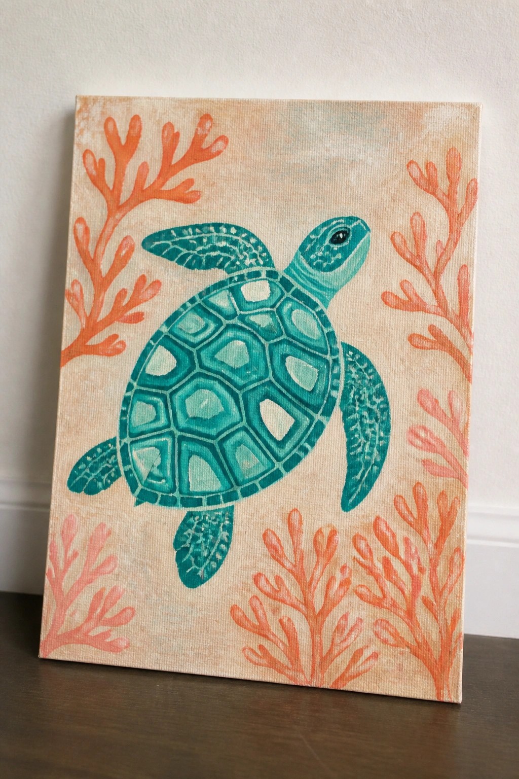 Teal sea turtle painting with orange coral on beige canvas background.