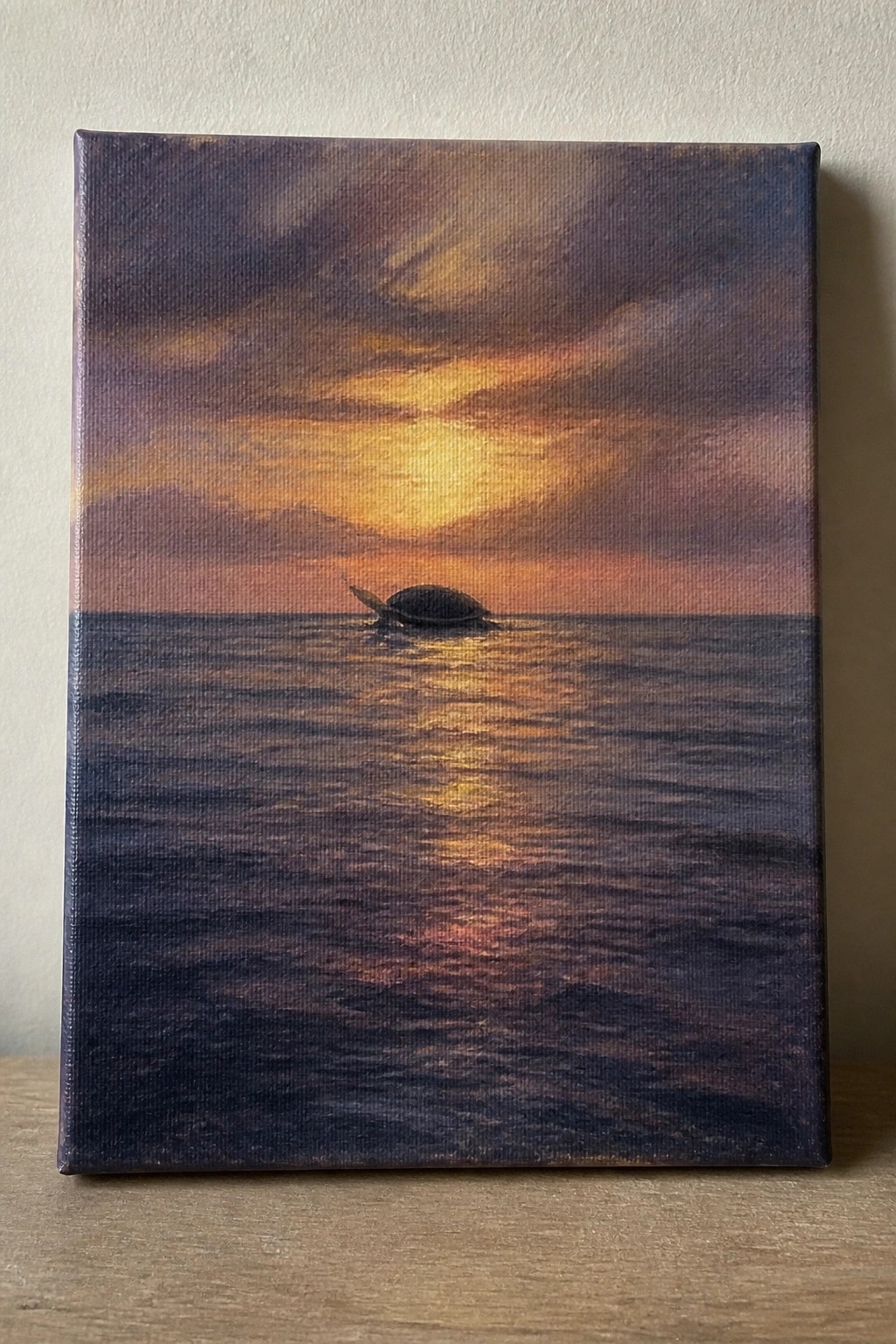 Sea turtle swimming in ocean under vibrant orange-purple sunset with golden reflections.