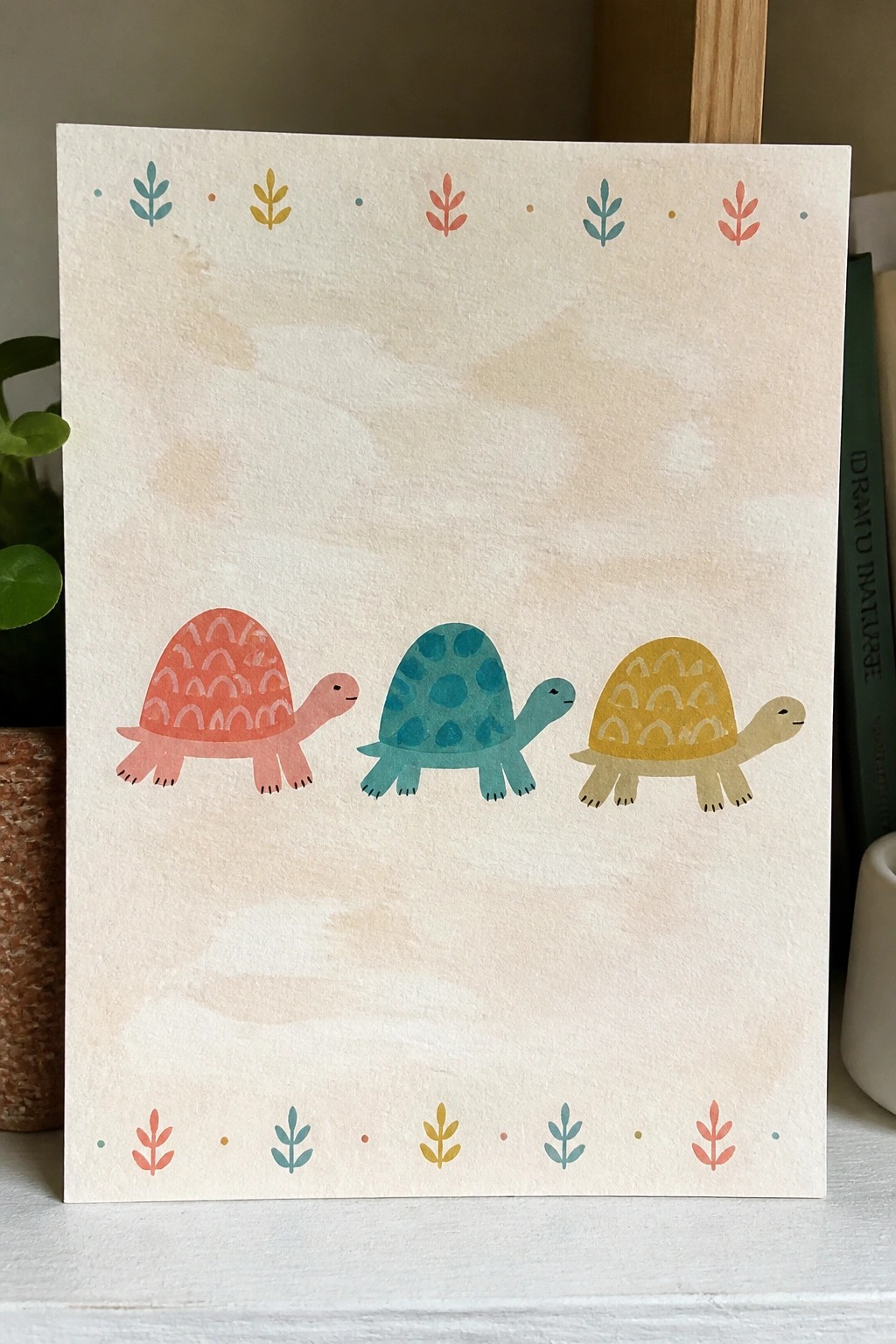 Three colorful turtles on a watercolor card with matching leaf-patterned borders