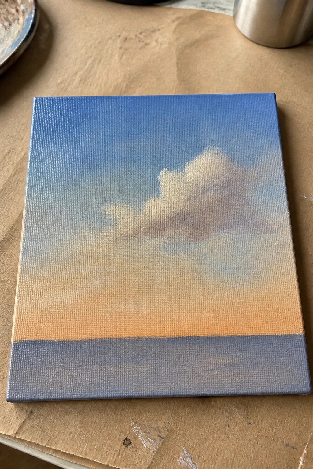 Square canvas with blue-to-orange sky gradient, fluffy cloud, and gray base strip