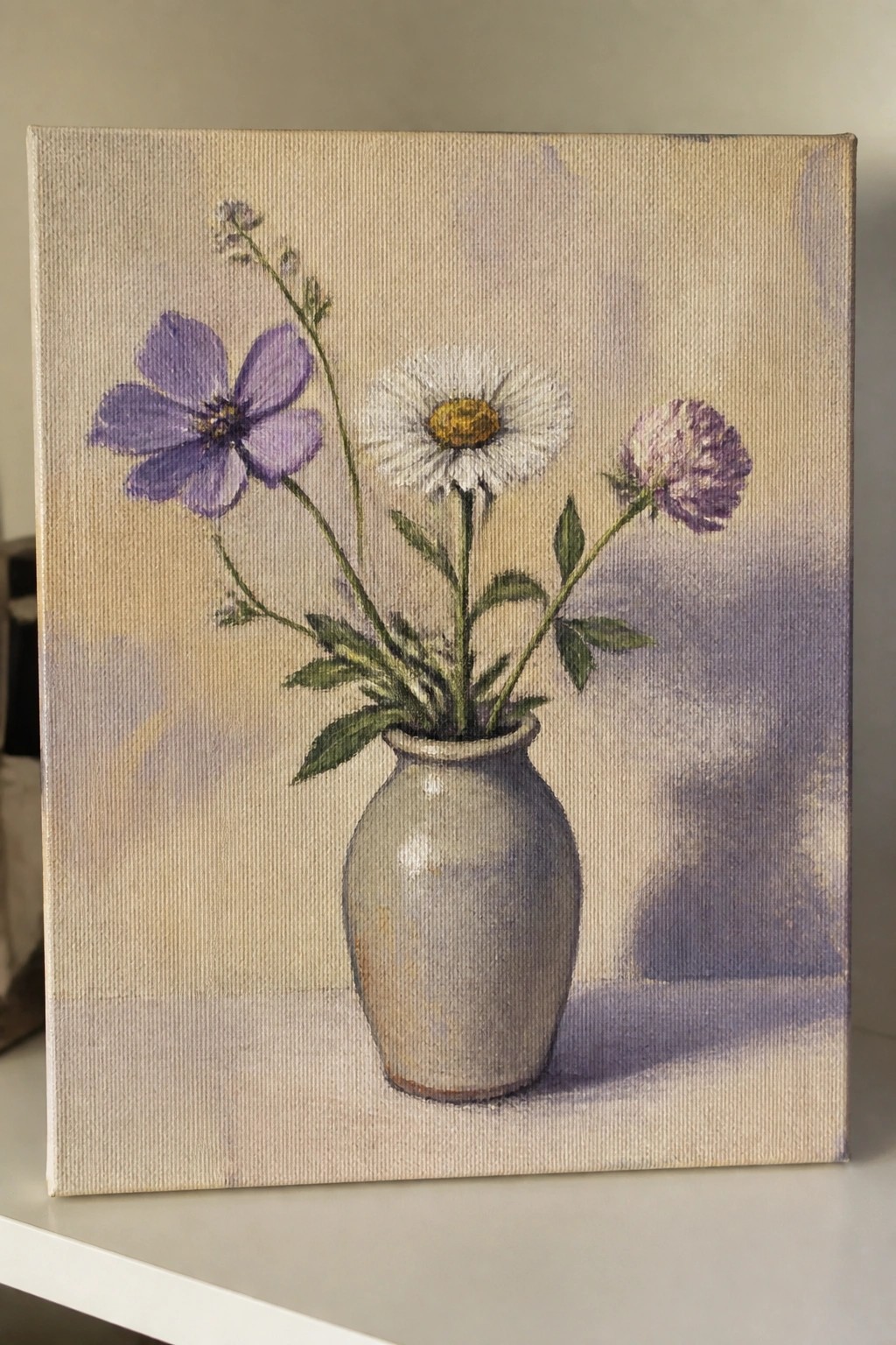 Still life painting of purple and white flowers in a gray ceramic vase