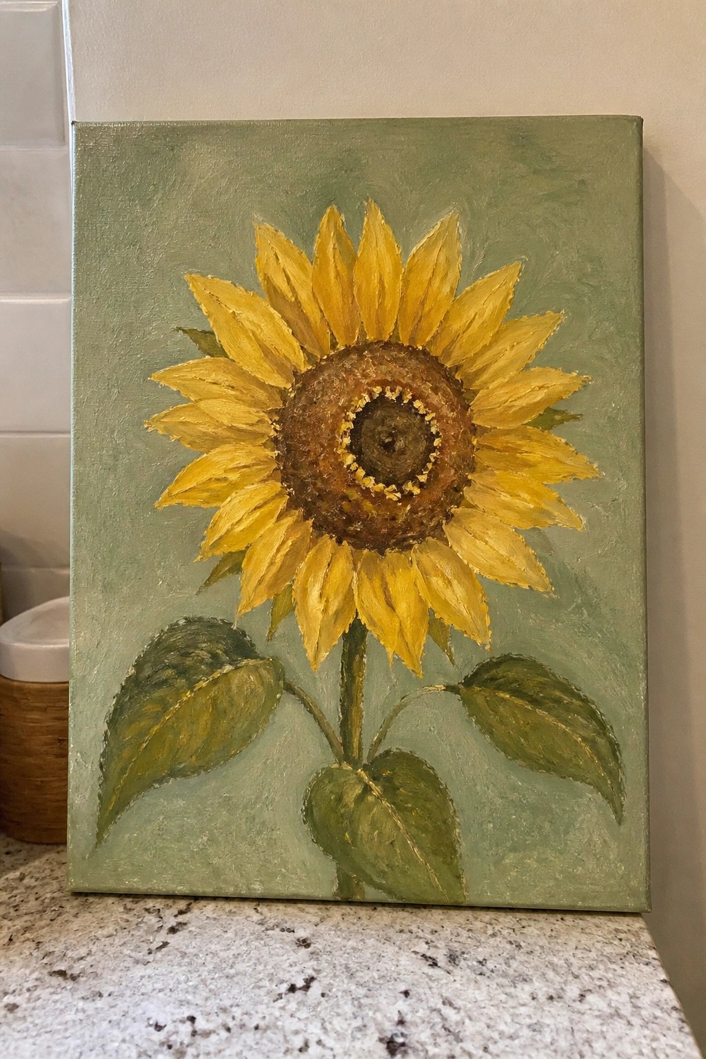 Yellow sunflower painting with brown center and green leaves on canvas.