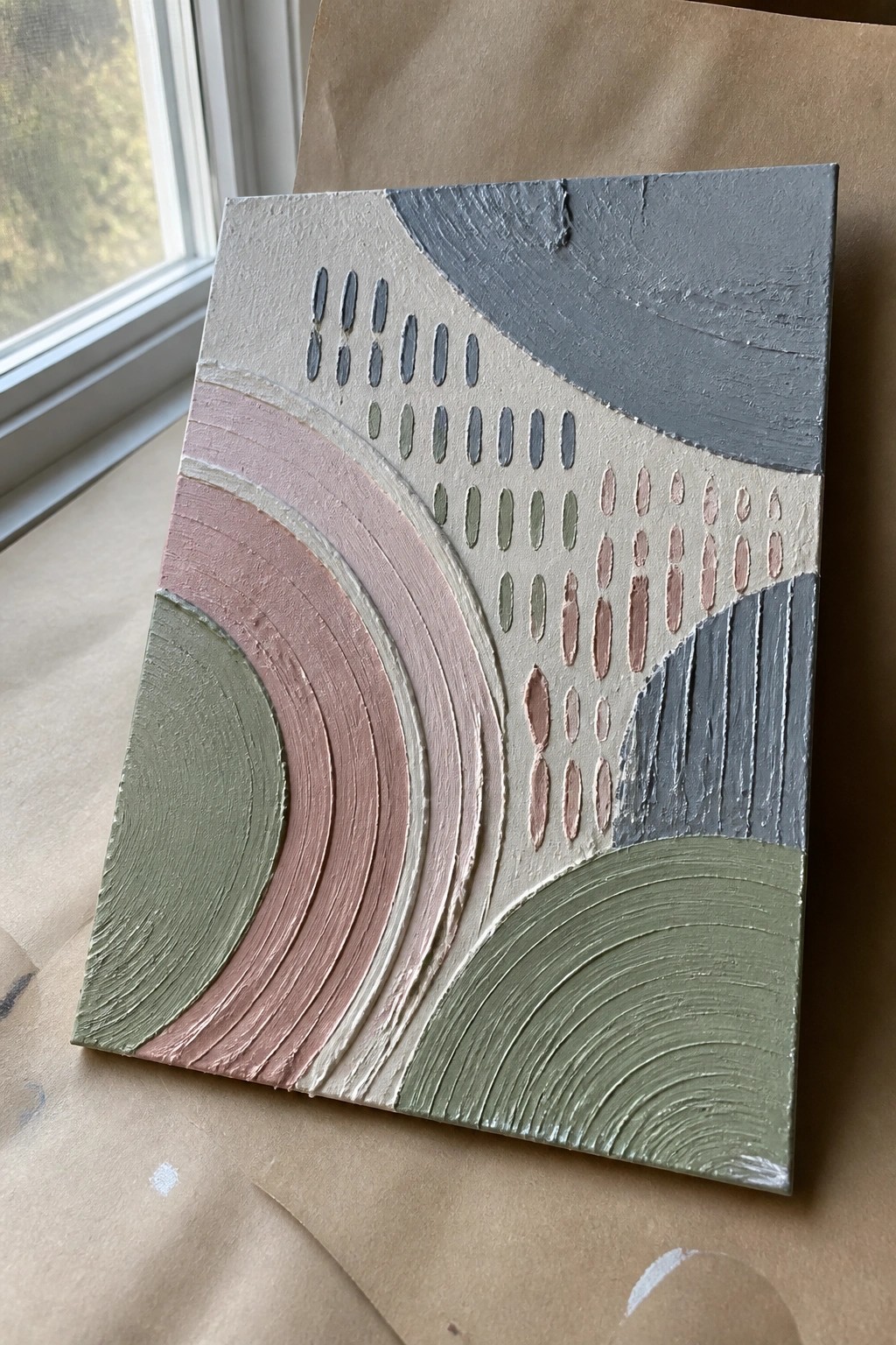 Textured abstract painting with curved bands and ovals in pink, green, and gray.