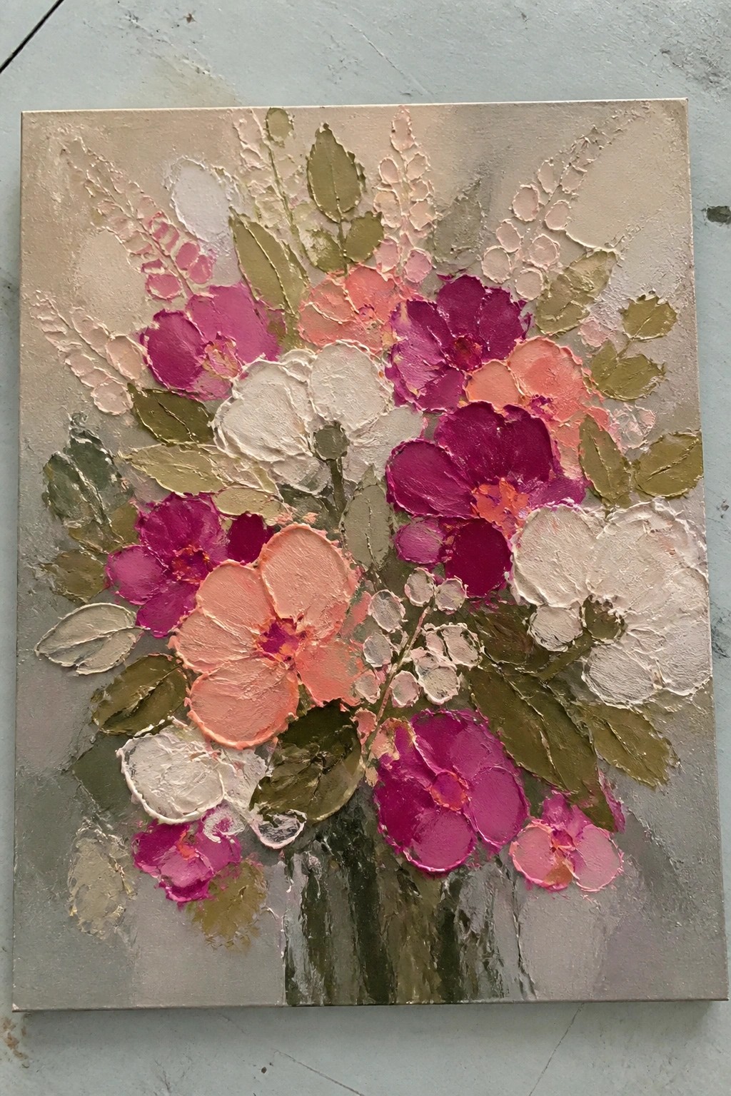 Textured impasto painting of pink, magenta and white flowers with green leaves on beige background