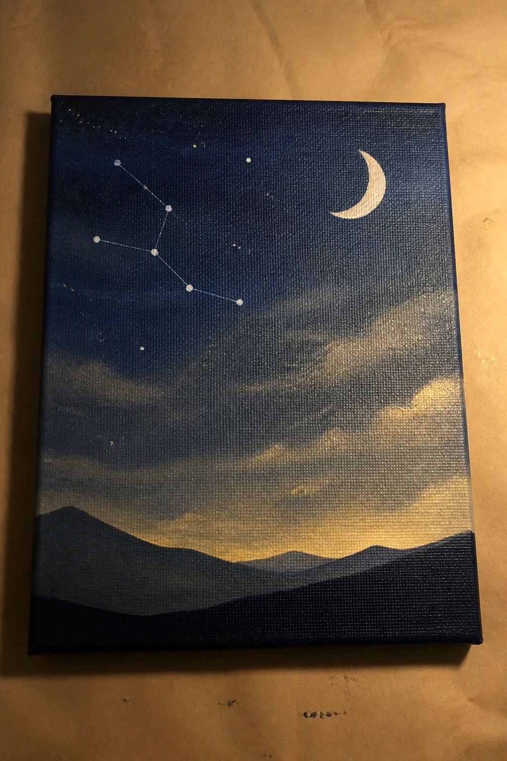 Night sky painting with crescent moon, connected stars, glowing clouds, and mountain silhouettes.