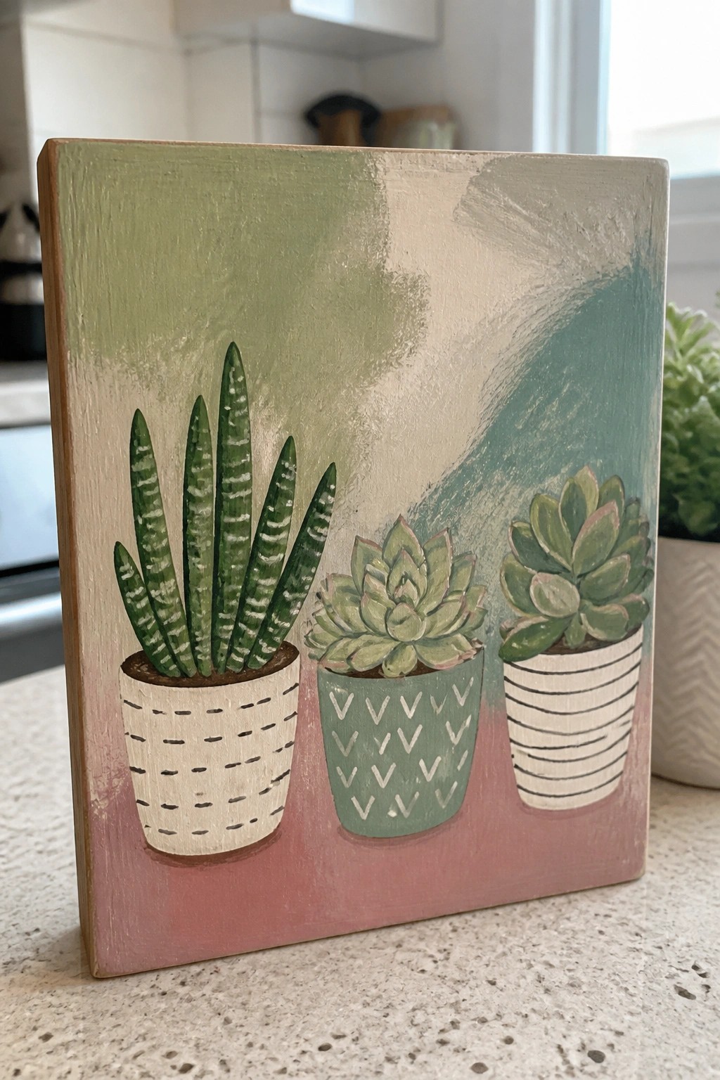 Painted wooden sign with three succulents in patterned pots on pink-green background