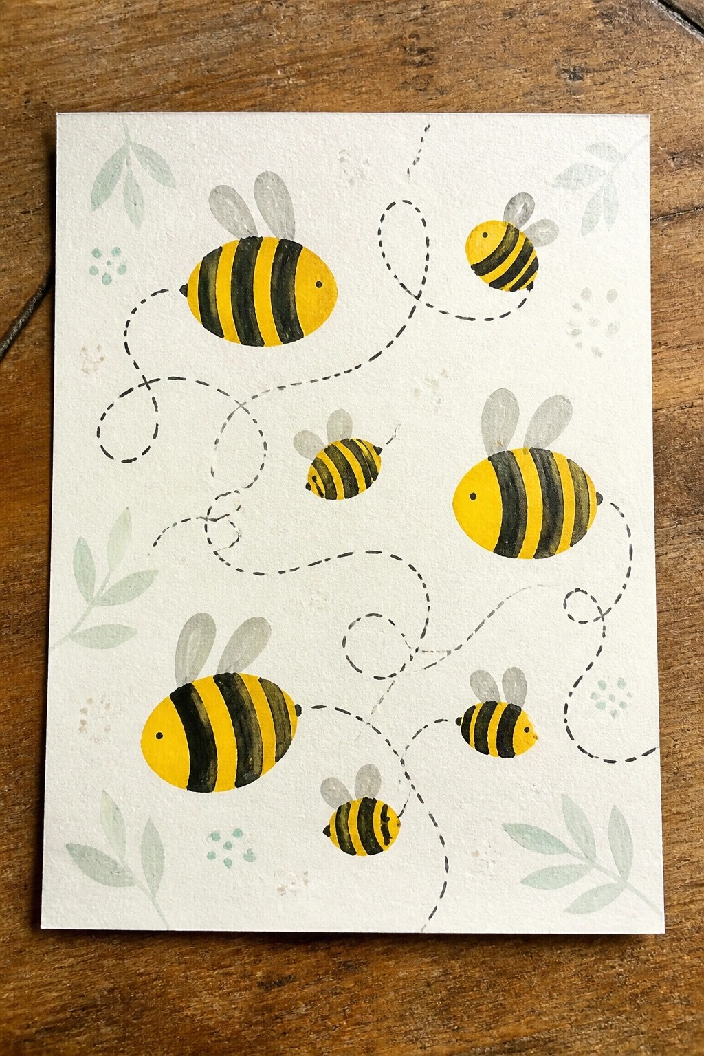 Yellow and black watercolor bees connected by dashed flight paths with green leaves.