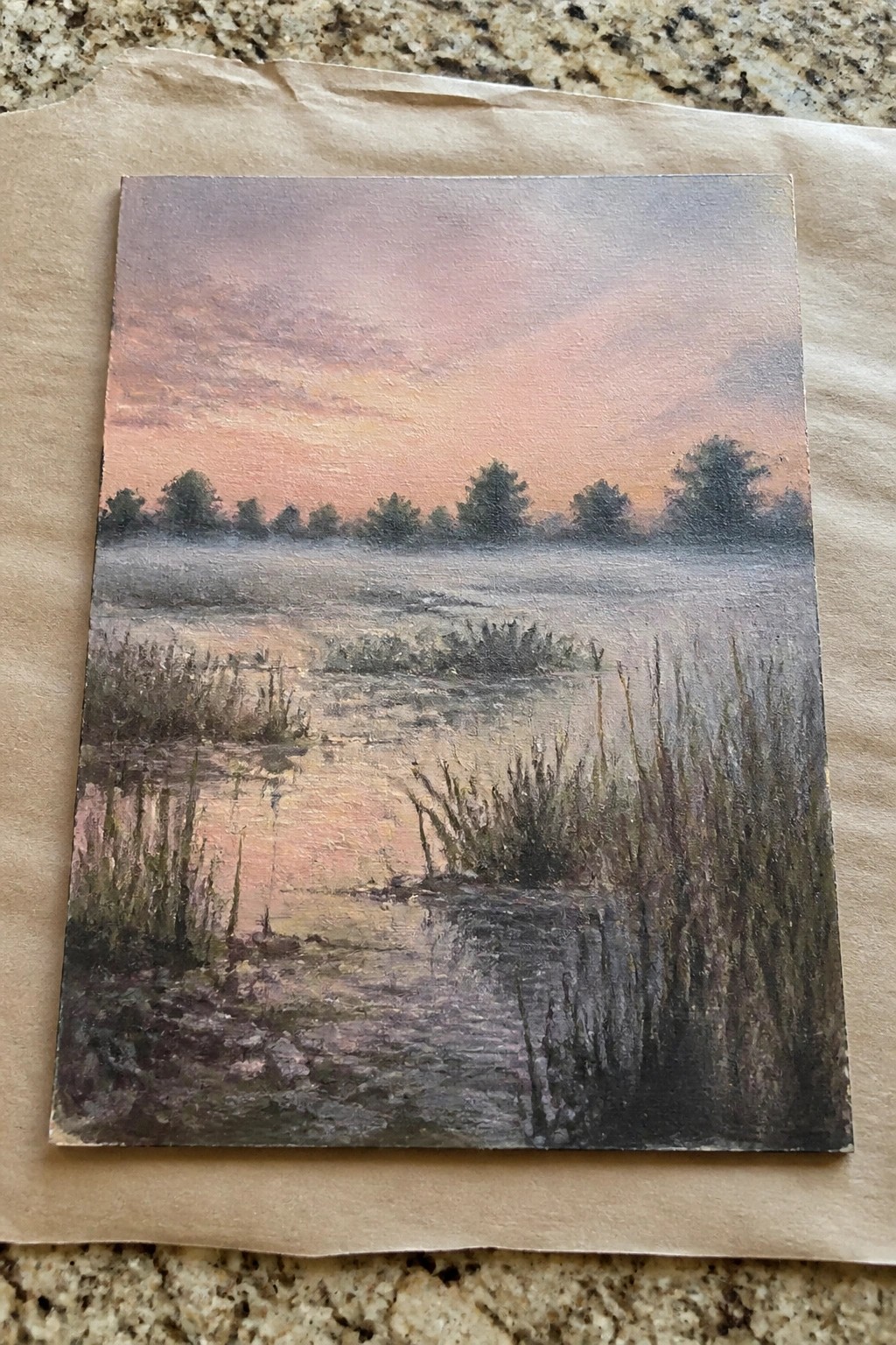 Misty marshland painting at sunset with pink-orange sky, reeds, and distant trees