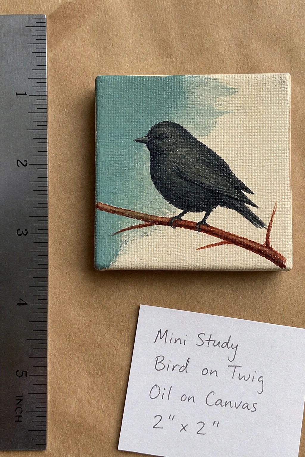Tiny 2x2 inch oil painting of black bird on twig with ruler and label