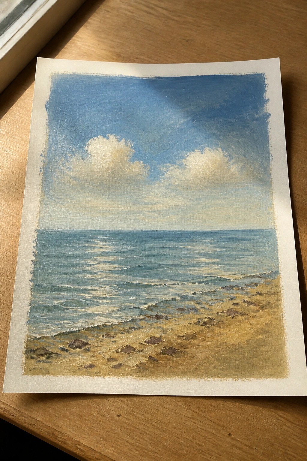 Seascape painting of blue ocean waves reaching a rocky sandy shore under cloudy skies.