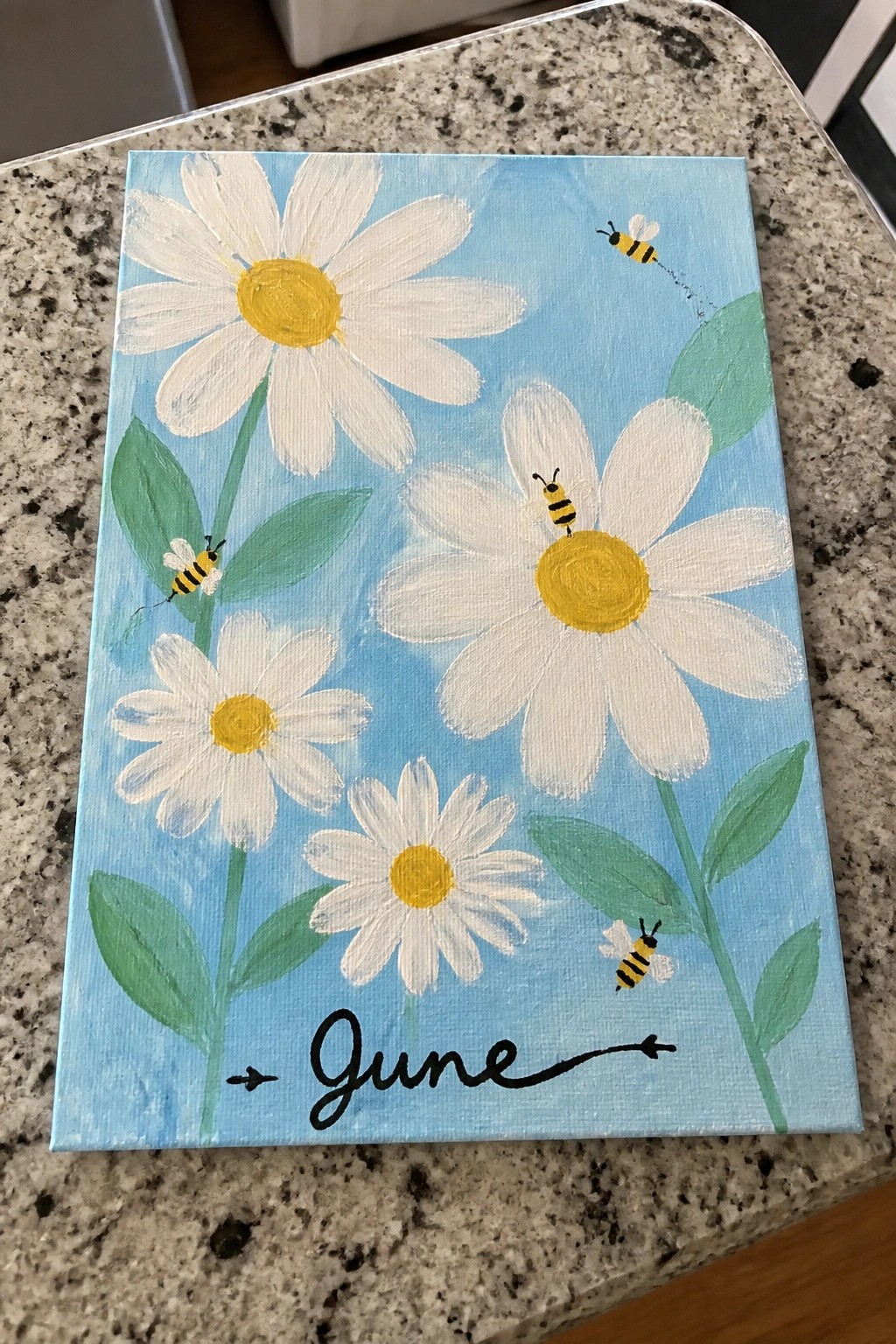 Colorful canvas painting of white daisies, bees, green leaves, and