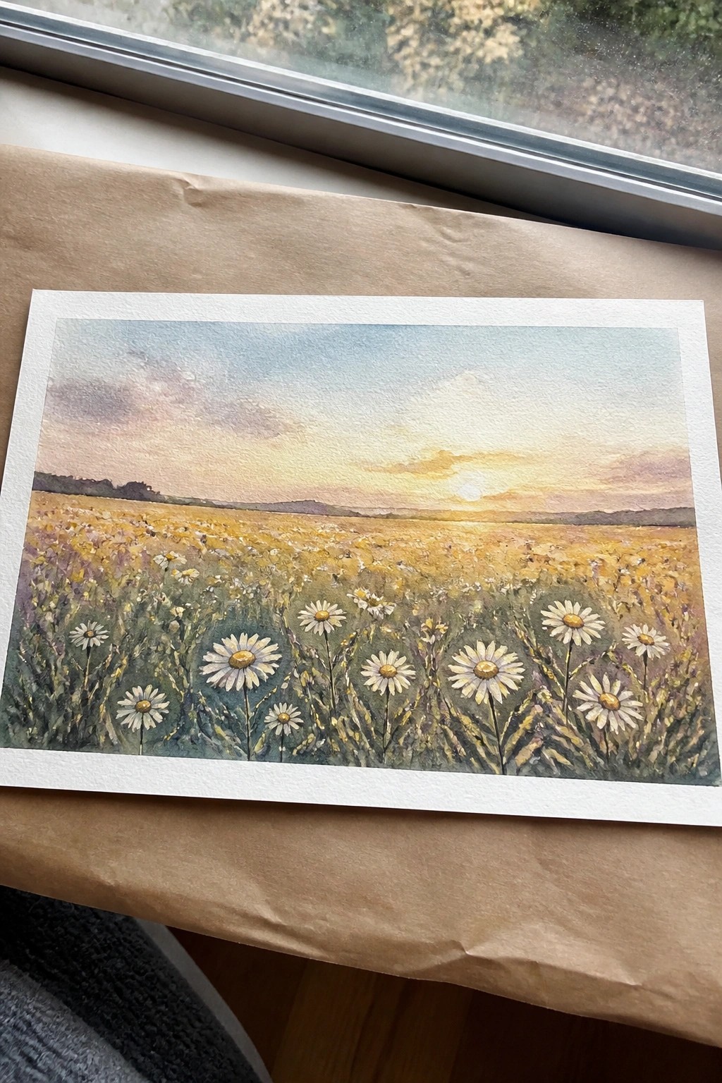 Watercolor of daisy meadow at sunset with golden field and pink sky
