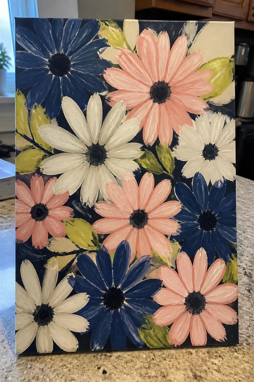 Abstract floral painting on canvas with pink, white, and blue daisies against dark background.