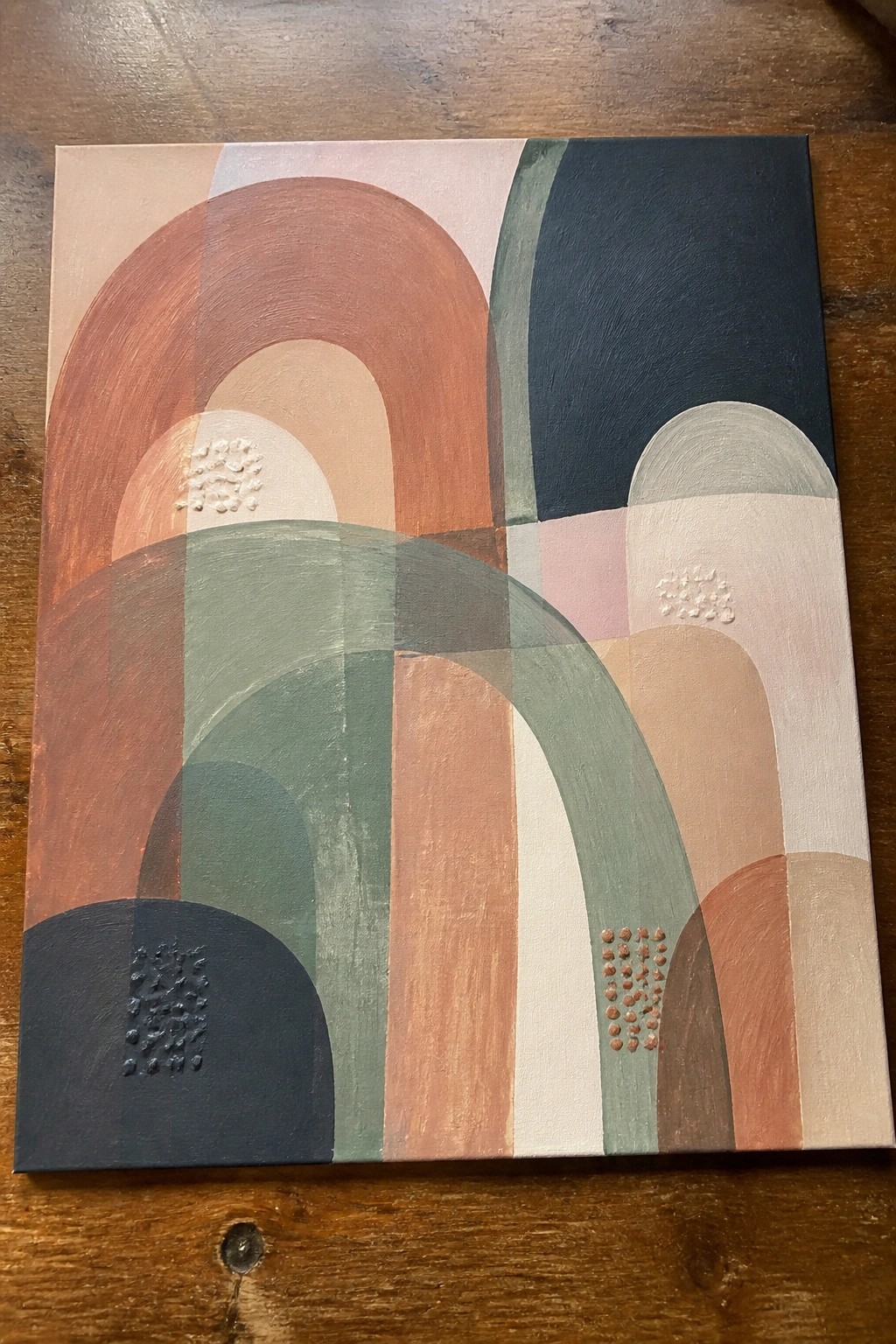 Abstract painting with overlapping arches in terracotta, sage green, navy, and blush.