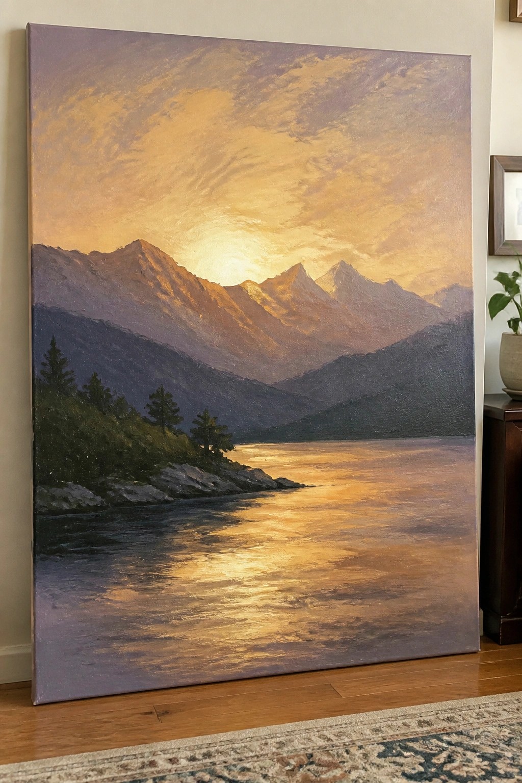 Sunset painting of golden light on mountains reflected in a winding river with trees.