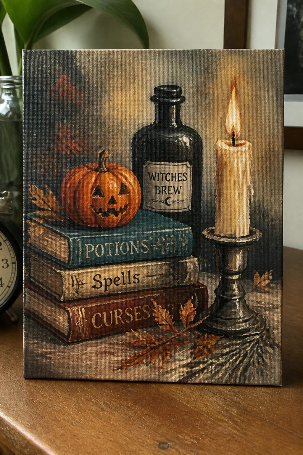 Still life painting with pumpkin on spell books, witches brew bottle, and lit candle