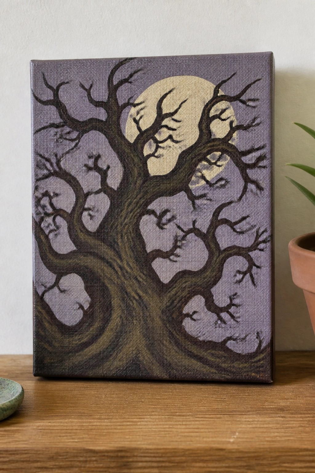 Gnarled bare tree with twisted branches against full moon on purple canvas painting