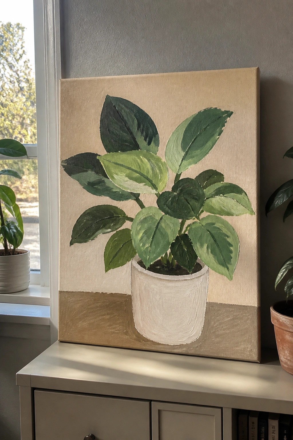 Canvas painting of leafy green plant in white pot on beige background