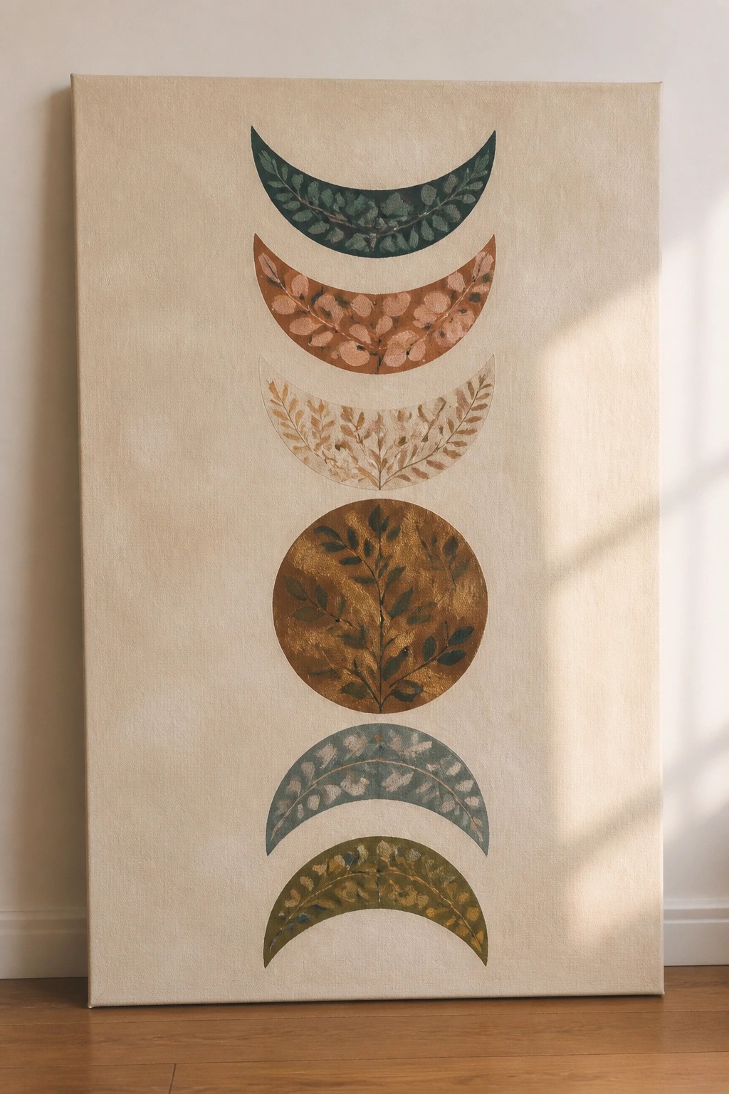 Abstract canvas art of moon phases with leafy botanical patterns in earthy tones.