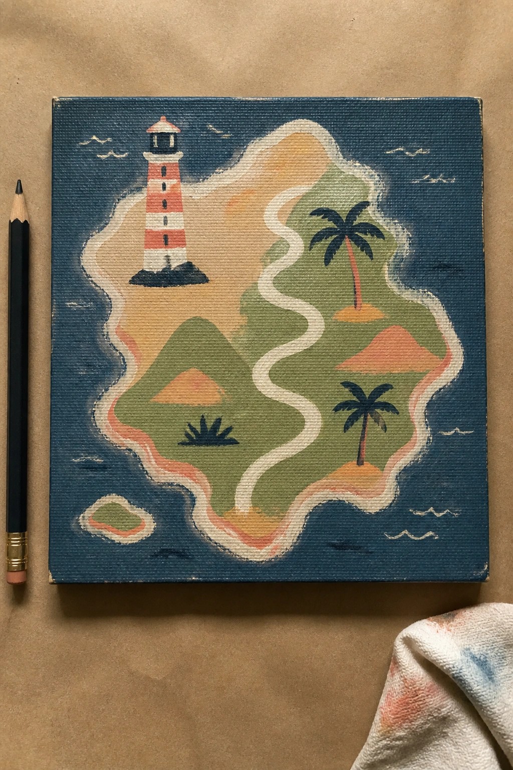 Colorful canvas painting of striped lighthouse on tropical island with palms beside pencil