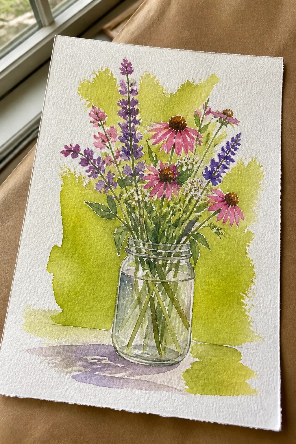 Watercolor of pink and purple wildflowers in glass mason jar with green wash