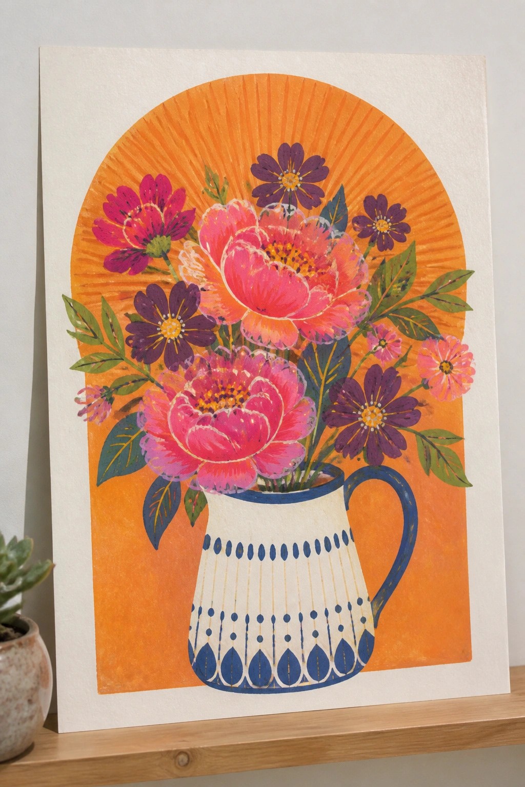Vibrant pink peonies and purple flowers in a patterned pitcher with orange sunburst background.
