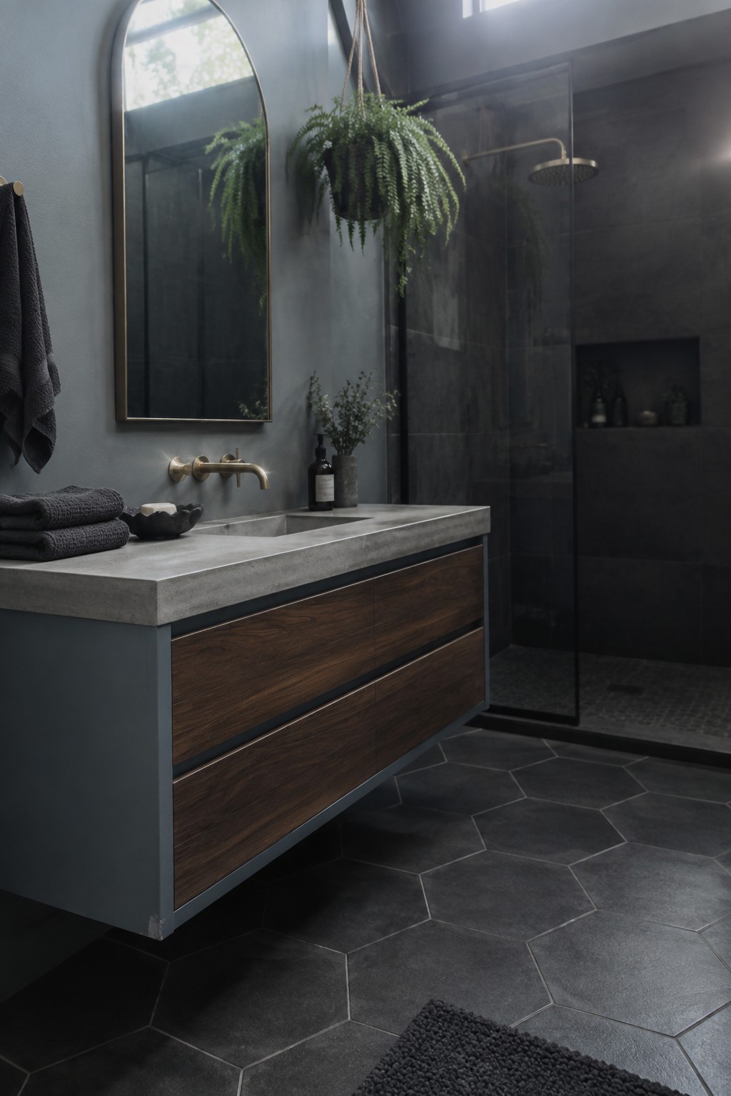 A bathroom vanity painted dark blue-gray with wood drawers and a concrete top.