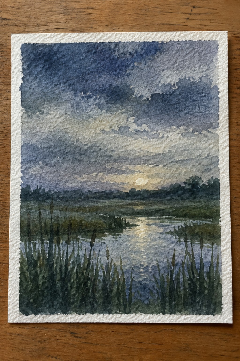 Watercolor sunset over marsh reeds with dramatic cloudy sky and golden horizon light
