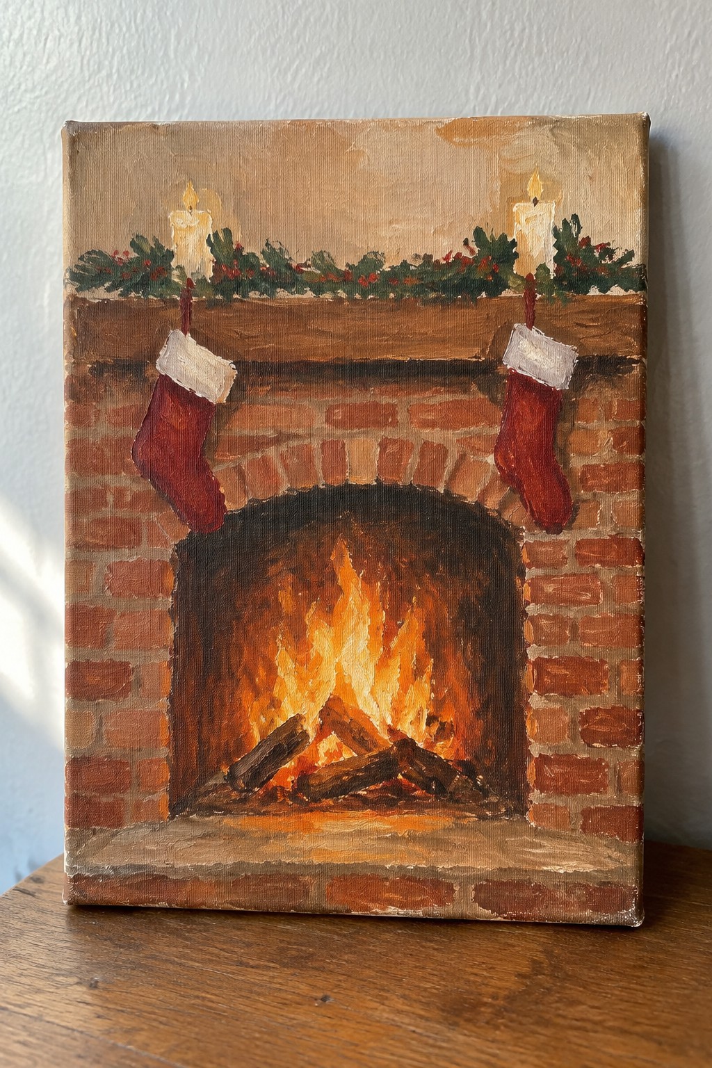 Cozy brick fireplace painting with roaring fire, red stockings, lit candles, and holly.