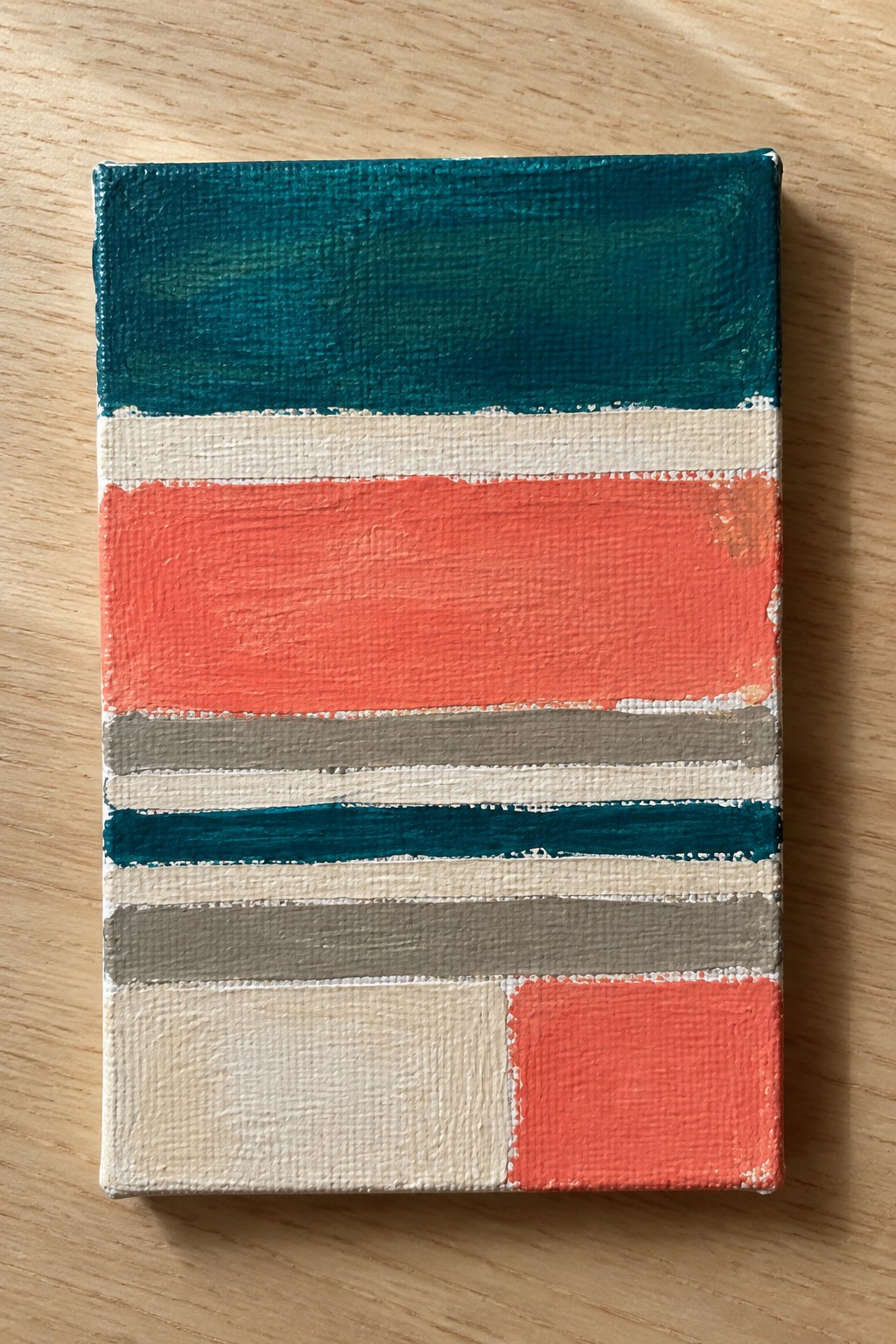 Abstract painting with horizontal stripes of teal, coral, gray, and cream on canvas.