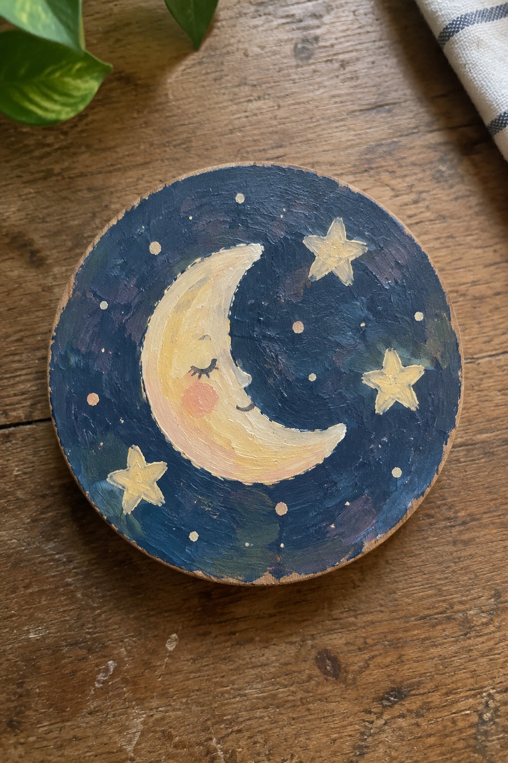 Hand-painted wooden disc with sleepy crescent moon, yellow stars on dark blue sky
