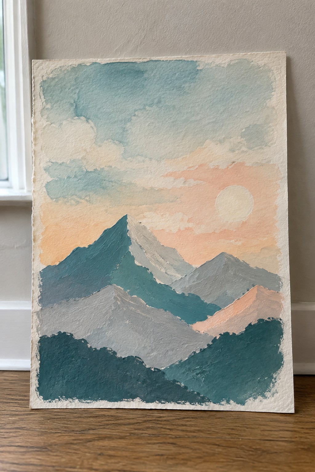 Layered mountain painting in teal and gray under peach sunset sky with sun