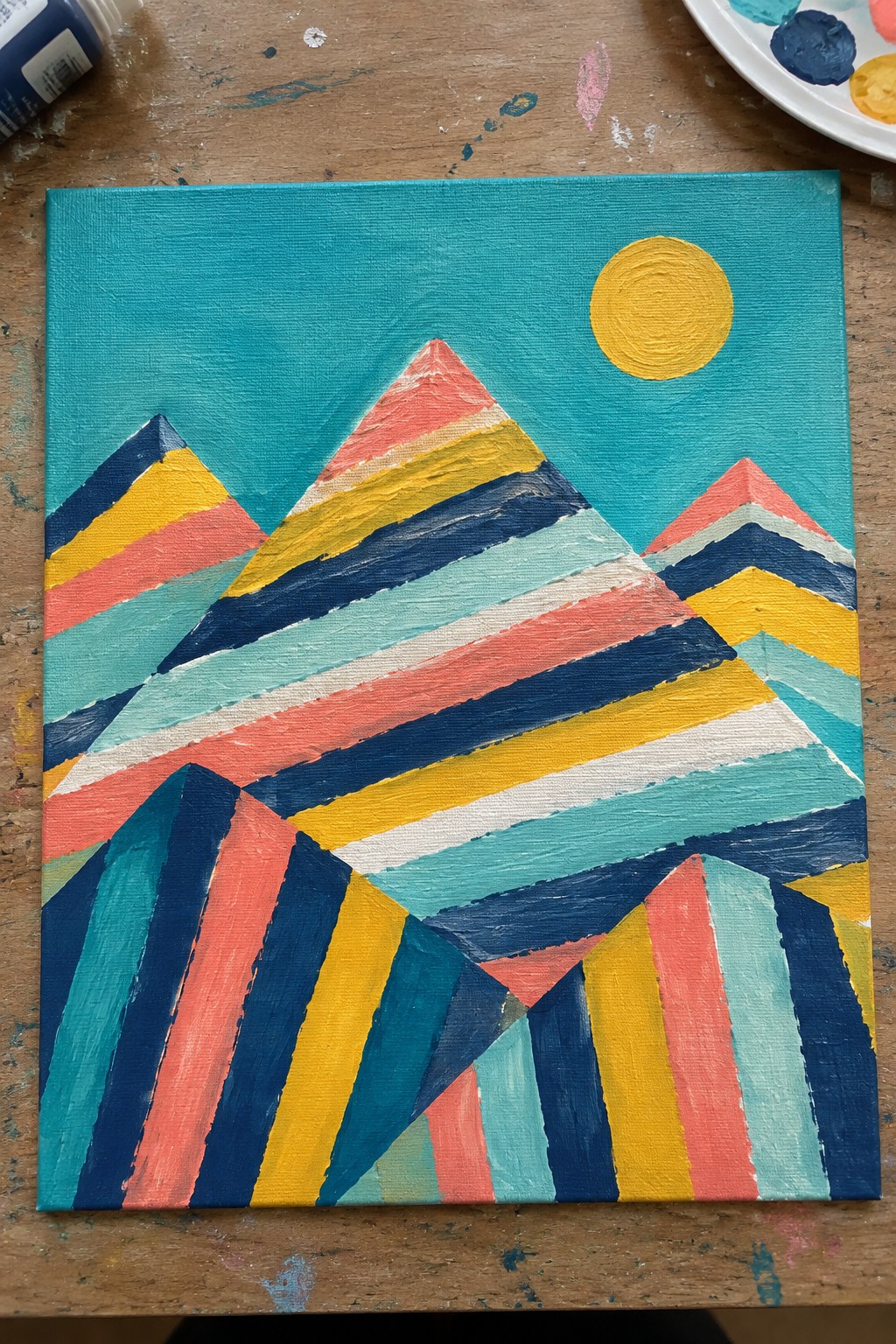 Vibrant striped mountain landscape painting on canvas with yellow sun in teal sky