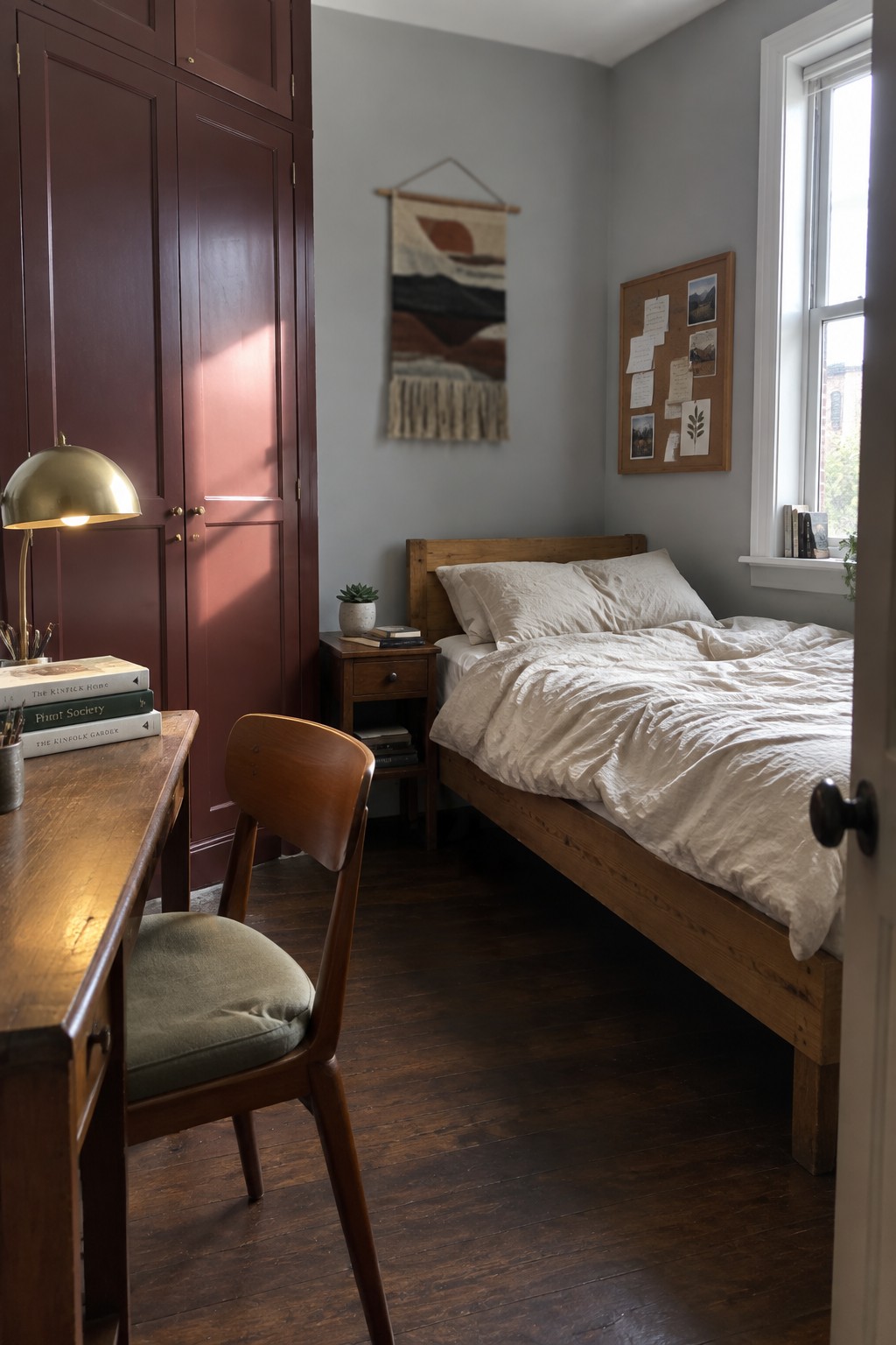 Bedroom walls painted in a soft charcoal gray next to warm wood furniture.