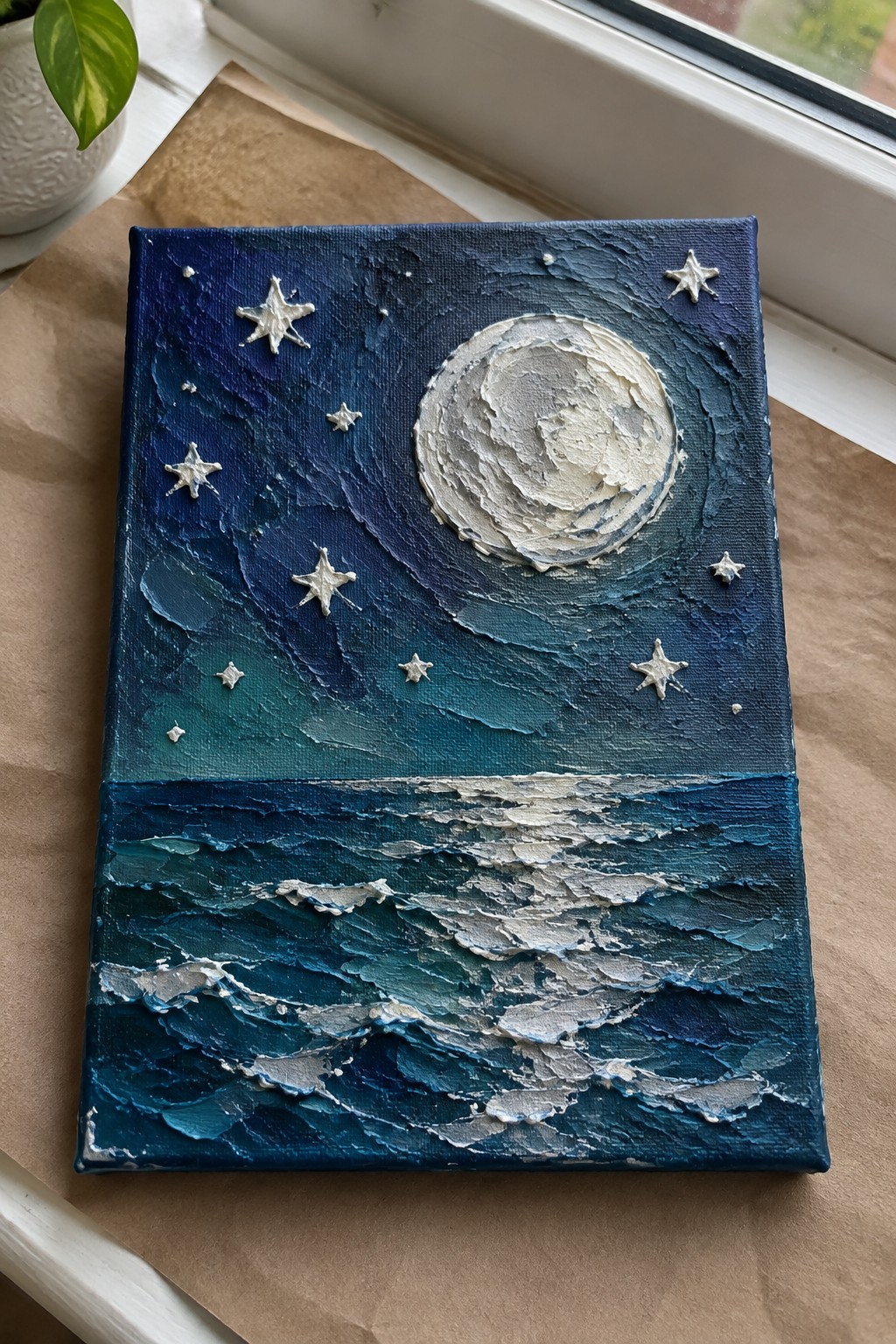 Textured painting of glowing full moon above starry blue sky and choppy ocean waves