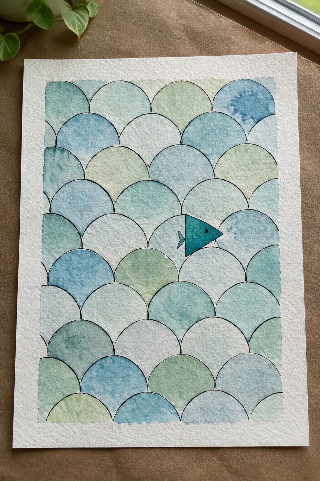 Watercolor fish scales in blue and green with a small teal fish