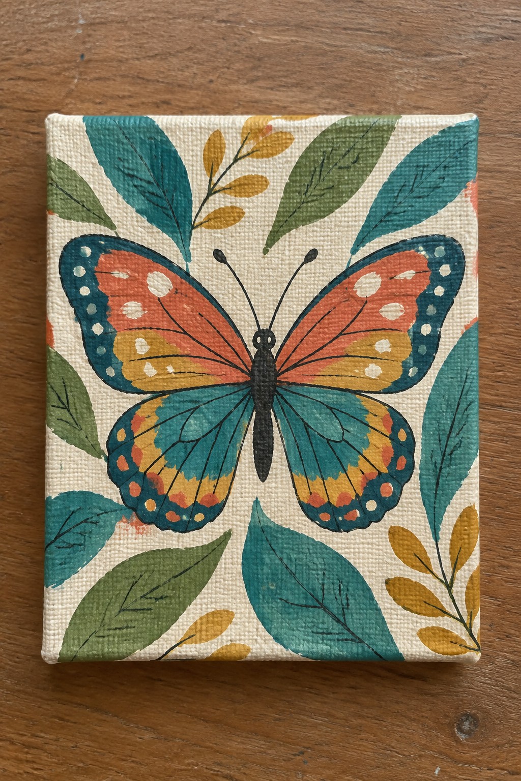 Colorful butterfly with teal orange wings amid green and yellow leaves on canvas