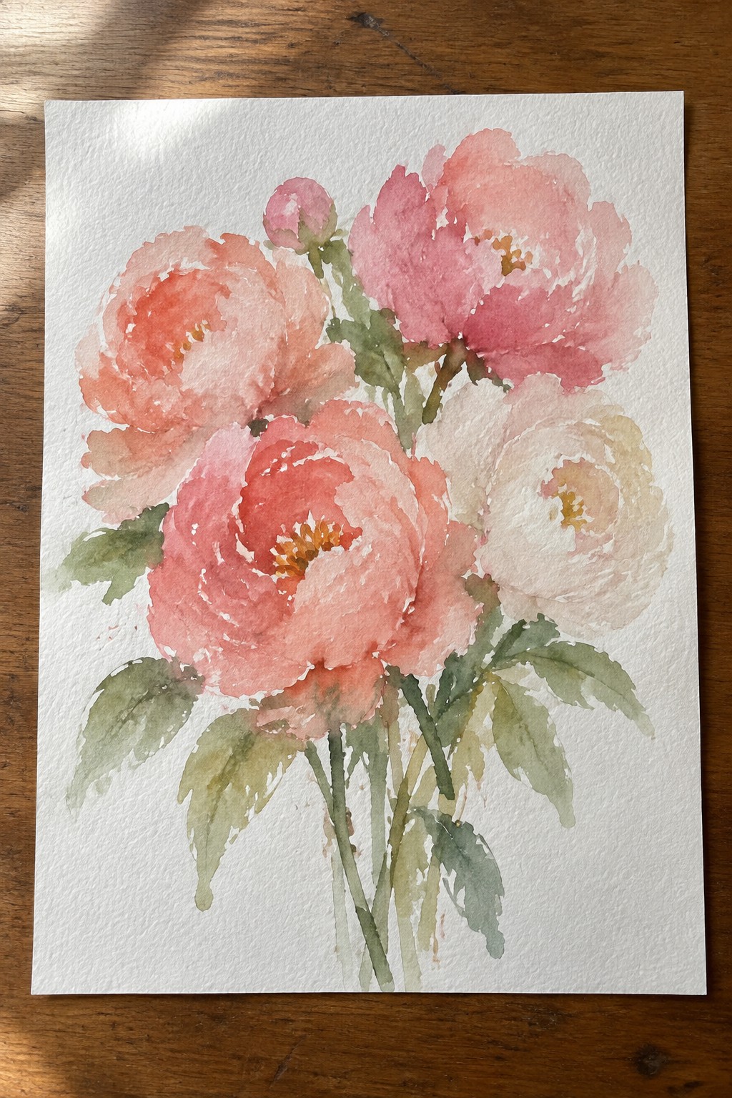 Watercolor painting of pink peonies with green leaves on wooden surface.