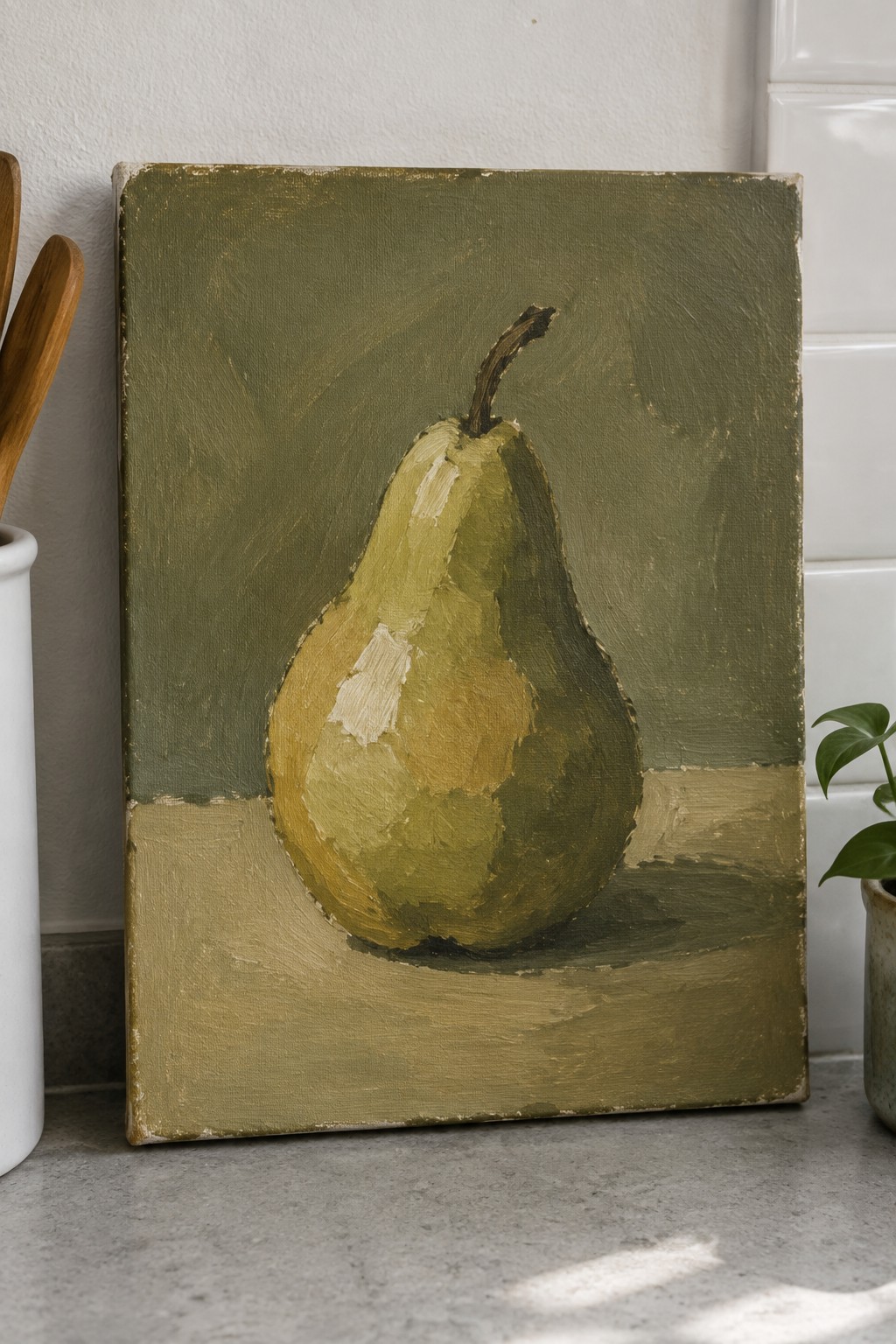 Still life painting of a yellow-green pear on textured canvas with green backdrop