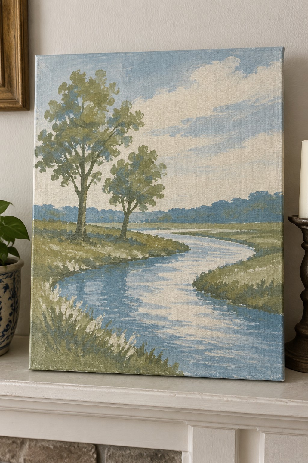 Landscape painting of winding river through green fields with trees on mantel