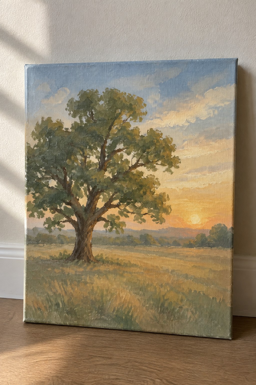 Oil painting of a large tree in a golden field at sunset
