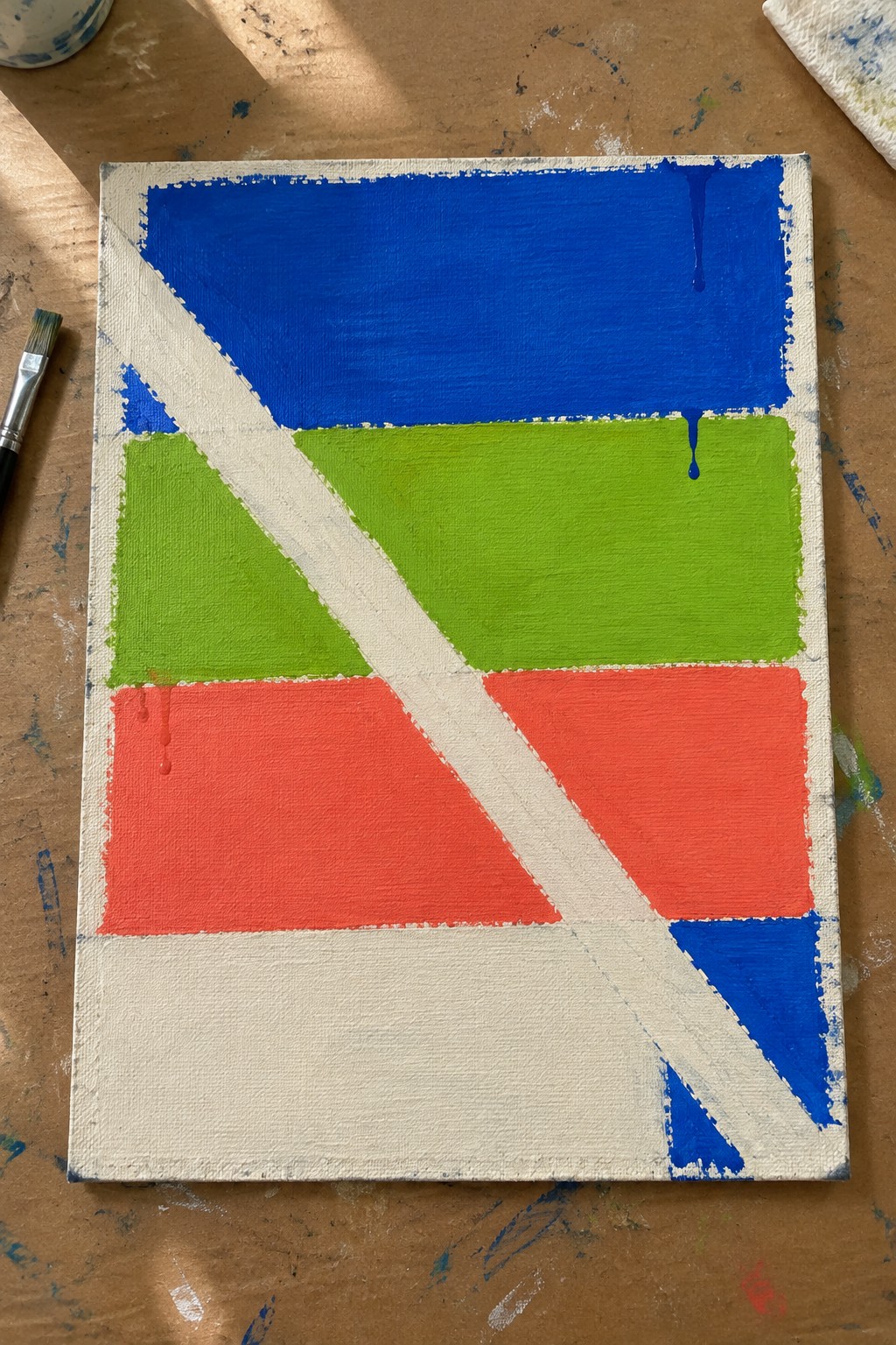 Abstract geometric painting with blue green red blocks, white diagonal stripe, and drips
