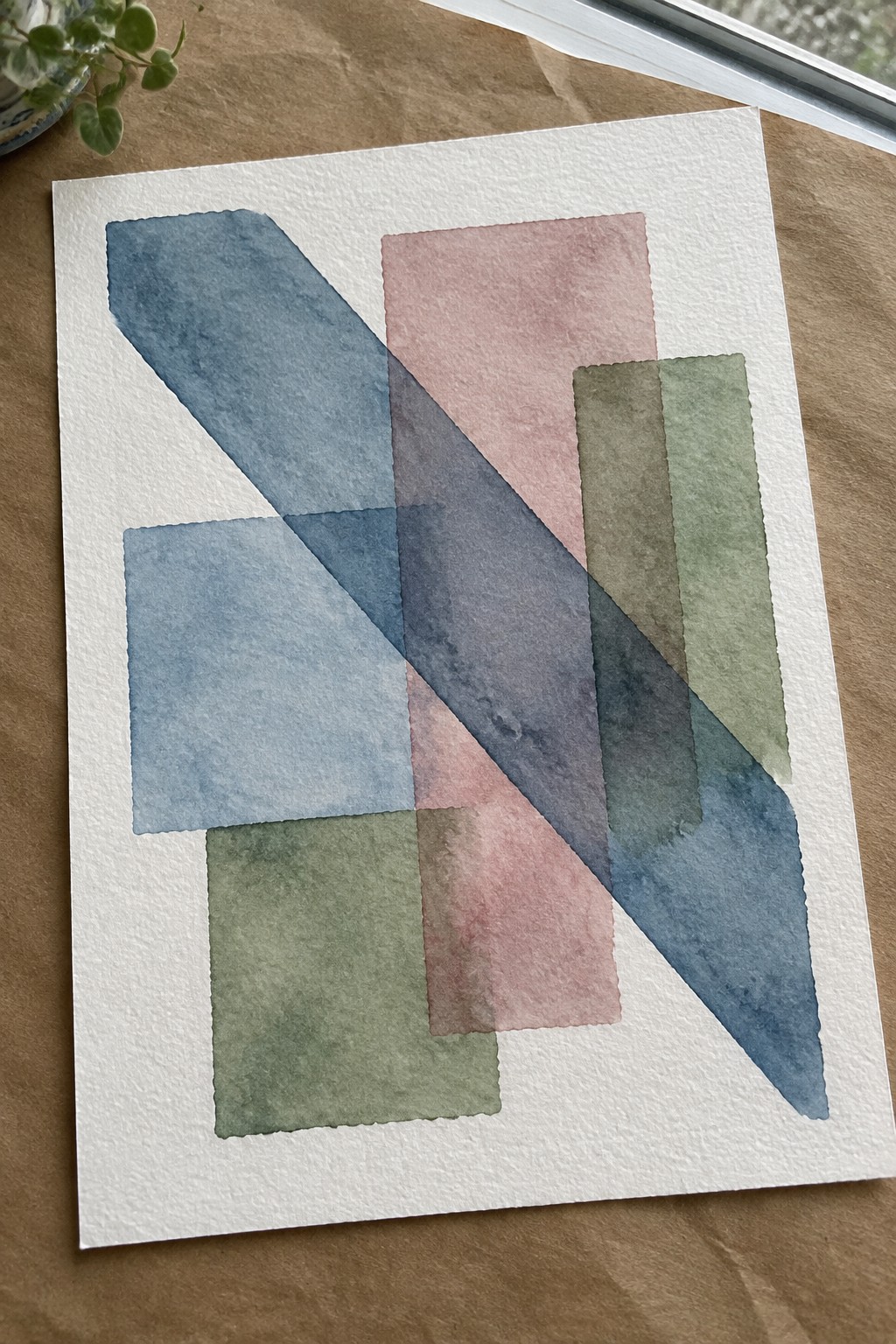 Abstract watercolor with overlapping blue diagonal stripe, pink, green, and blue rectangles on white paper