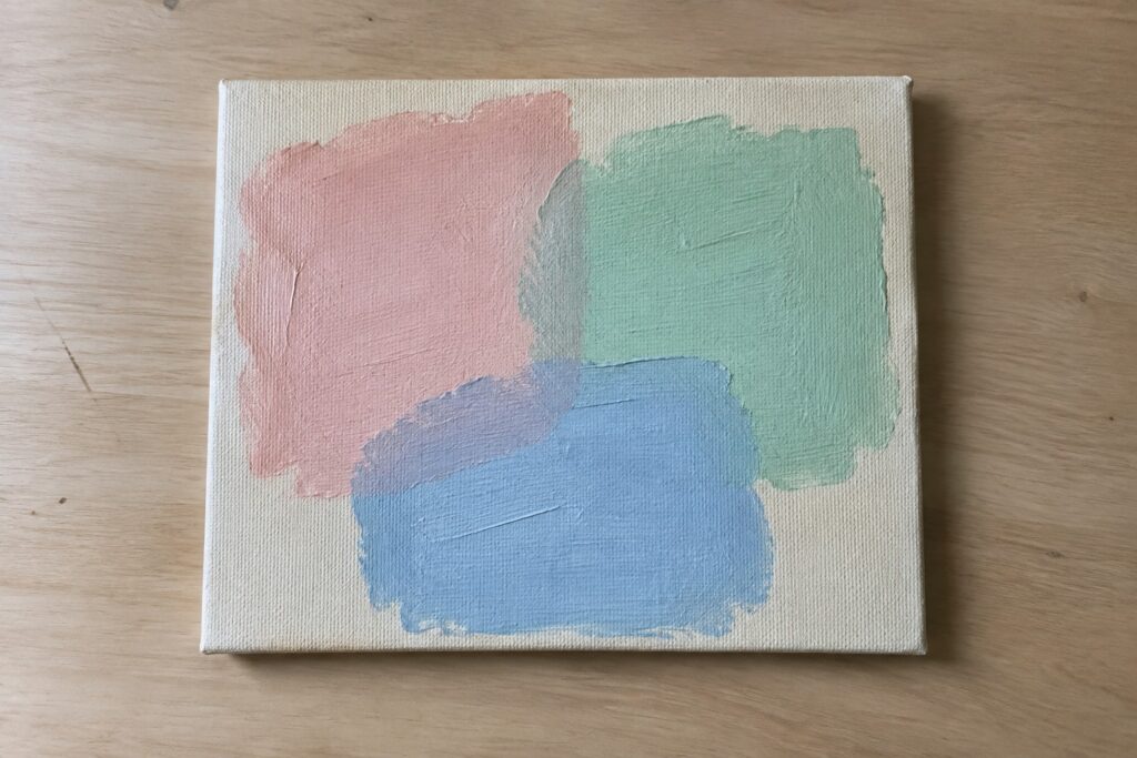 21 Aesthetic Acrylic Painting Ideas in Soft Pastel Colors Abstract canvas with overlapping pink, blue, and mint green brushstrokes on wood